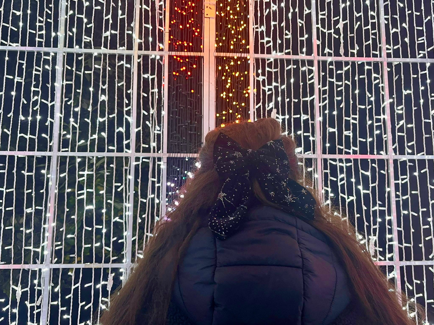 owner of sew much love standing by christmas lights wearing Celestial Black Velvet Hair Bow