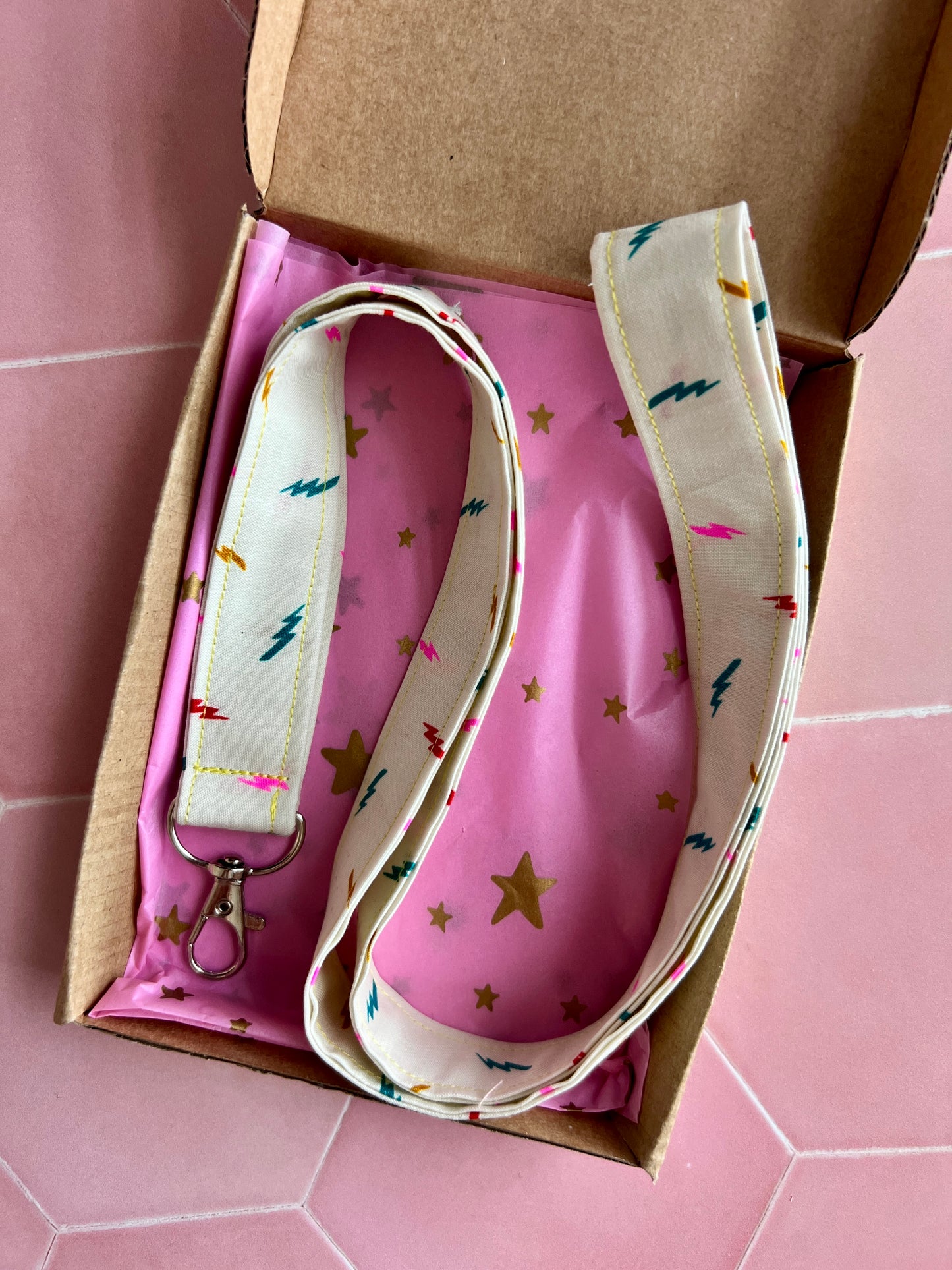 Cream lightning bolt fabric lanyard, handmade and gift-wrapped in pink starry tissue and kraft eco-friendly box