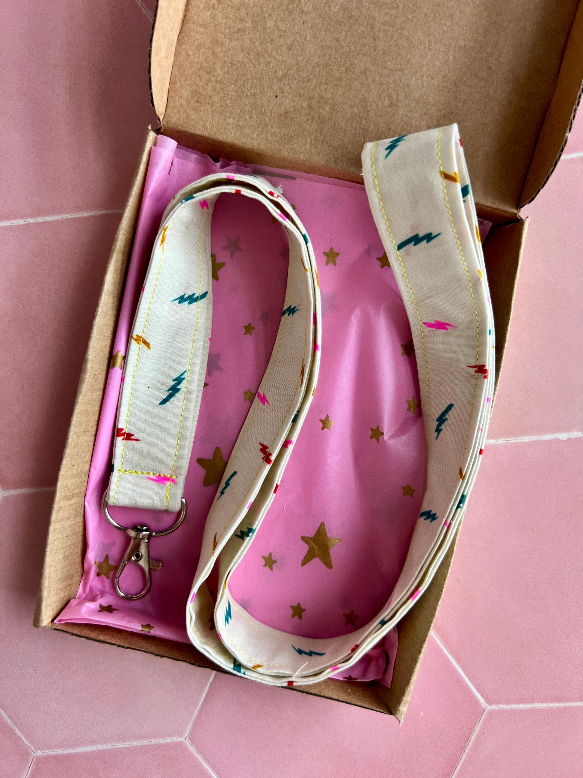 Cream lightning bolt fabric lanyard, handmade and gift-wrapped in pink starry tissue and kraft eco-friendly box